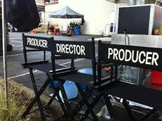 three director chairs in video village on a movie set